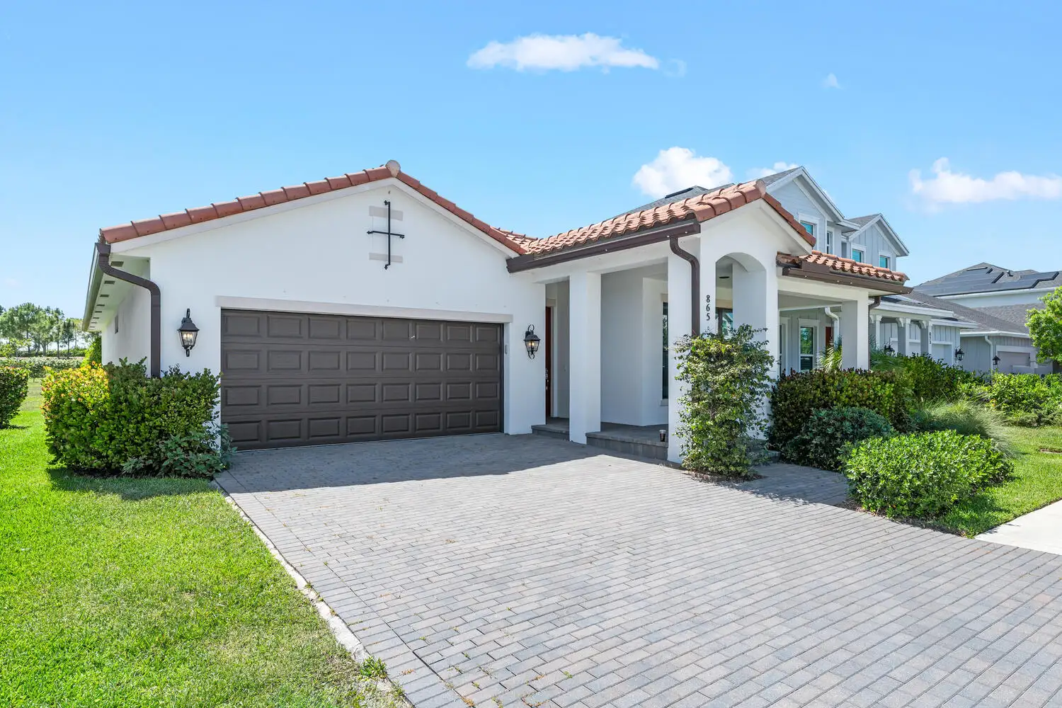Image of the front of a white Spanish style home